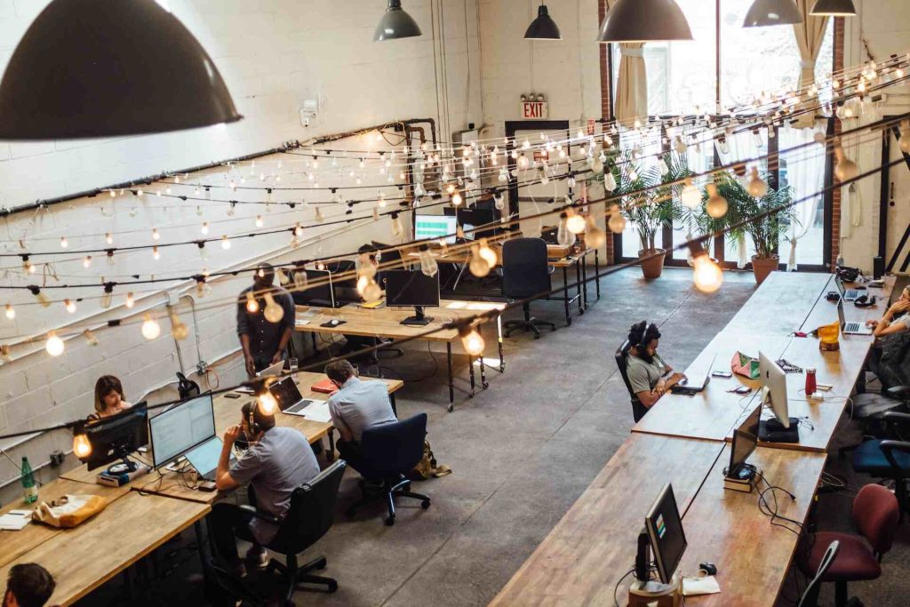Top view of an office. Several people are working while connected a TŌGŌ intranet.